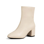 Angled front view of beige ankle boot on white background highlighting smooth faux leather finish