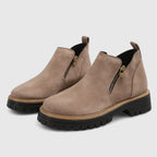 Taupe suede ankle boots with black lugged platform sole and heel pull tab detail