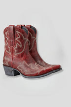 Pair of red leather ankle boots with cream embroidered stitching and pointed toe, side view