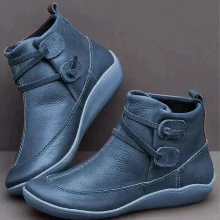 Pair of blue leather ankle boots featuring a lace-up front and cushioned low heel