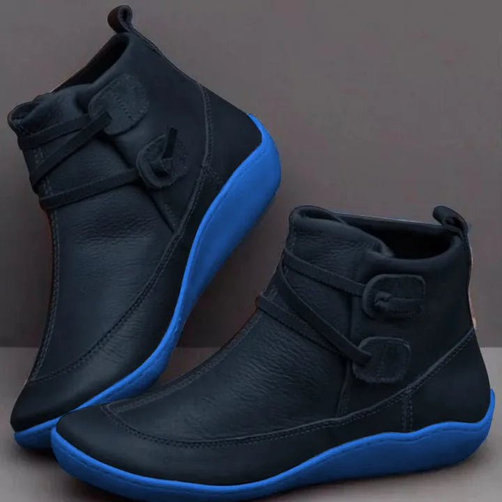 Navy ankle boots with bright blue contrast sole and decorative front lacing detail