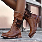 Close-up side view of brown leather lace-up ankle boots with studded trim and stacked wooden-style heel