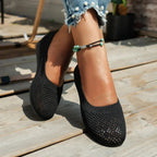 Burgundy ballet flat held in hand showing the soft knit fabric and rounded toe shape