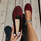 Burgundy mesh ballet flats displayed side by side, one held to show quilted footbed detail
