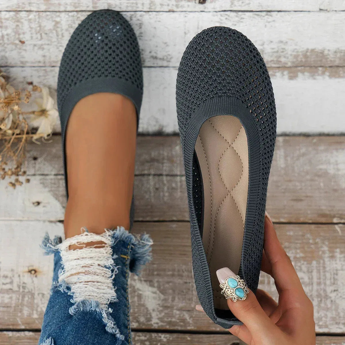 Close-up of black knit ballet flat showing breathable perforated mesh texture on the toe