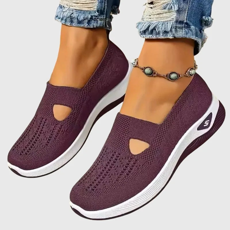 Purple knitted trainer sole detail with white ridged outsole and side logo emblem