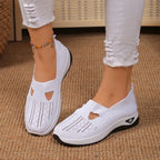 Beige knitted slip-on trainers with visible perforation pattern and cushioned white midsole