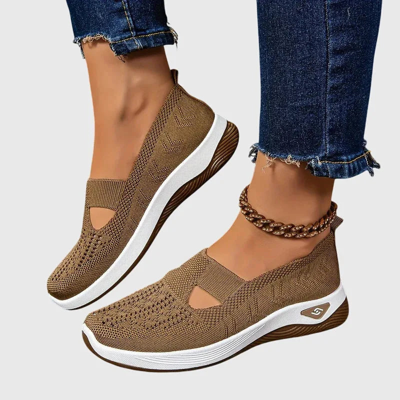 Pair of brown knitted slip-on trainers with white ridged soles and gold ankle chain accessory
