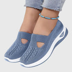 Blue knitted slip-on trainers with cut-out detail and thick white sole, worn with cropped jeans