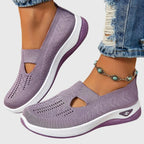 Purple knitted slip-on trainers worn on feet with cropped jeans and turquoise beaded anklet