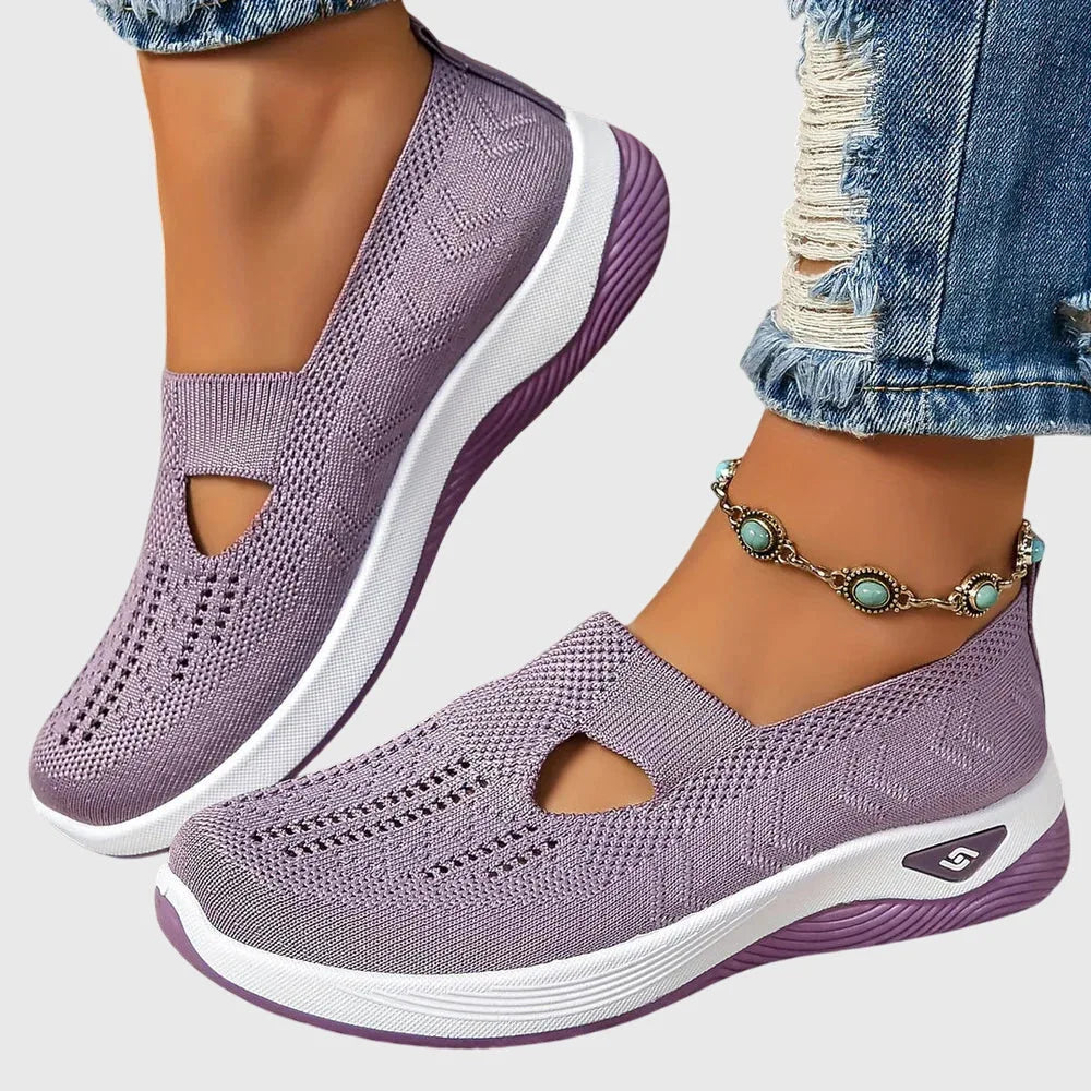 Purple knitted slip-on trainers worn on feet with cropped jeans and turquoise beaded anklet