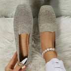 Beige knitted slip-on flats shown from above with tan cushioned insole and perforated toe panel