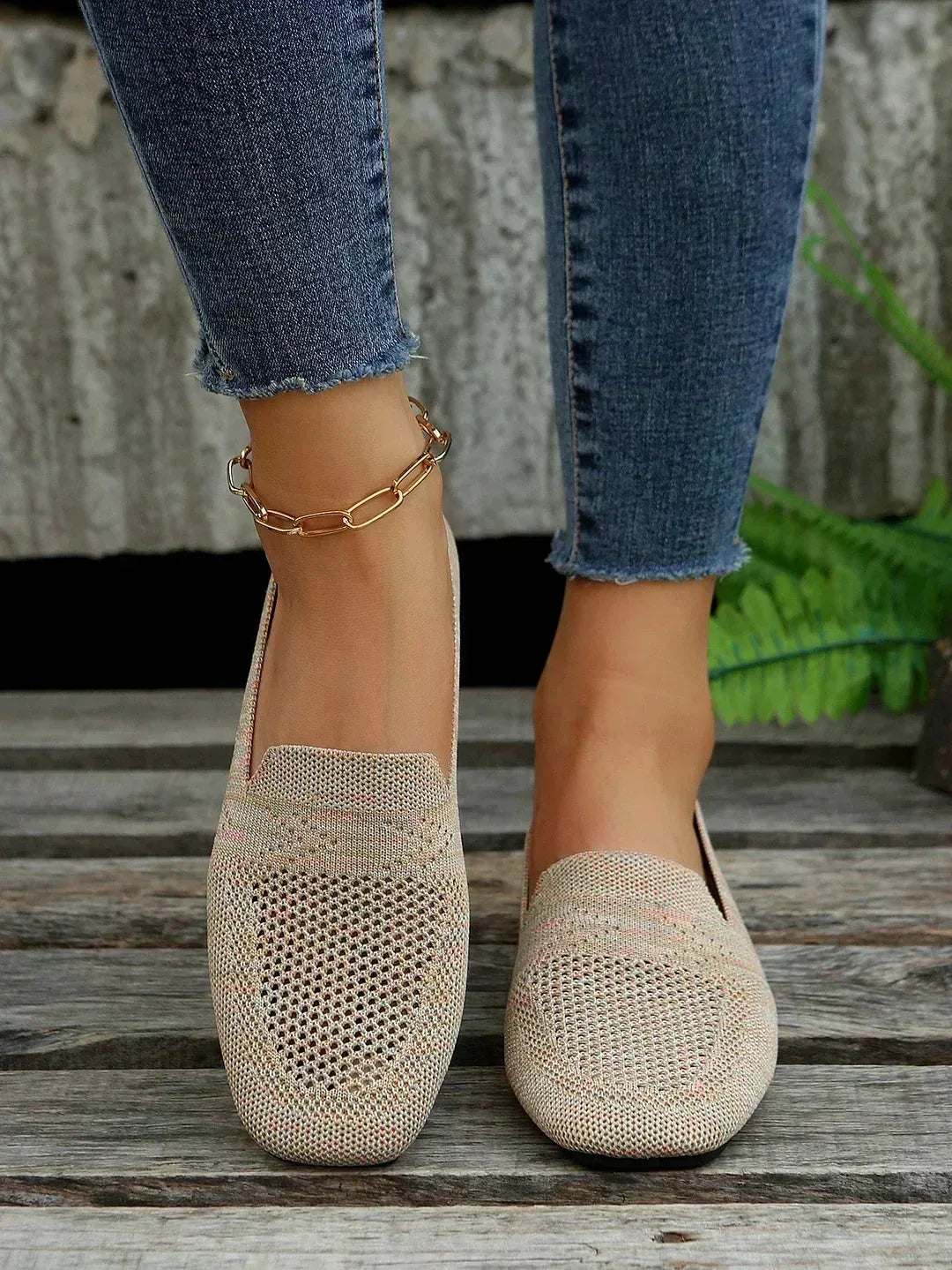 Purple knitted flats with pearl ankle bracelet, close-up of toe perforation and knit weave