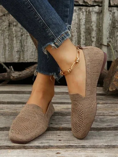 Beige mesh flats worn on foot with cropped jeans, showing side profile and low-cut vamp