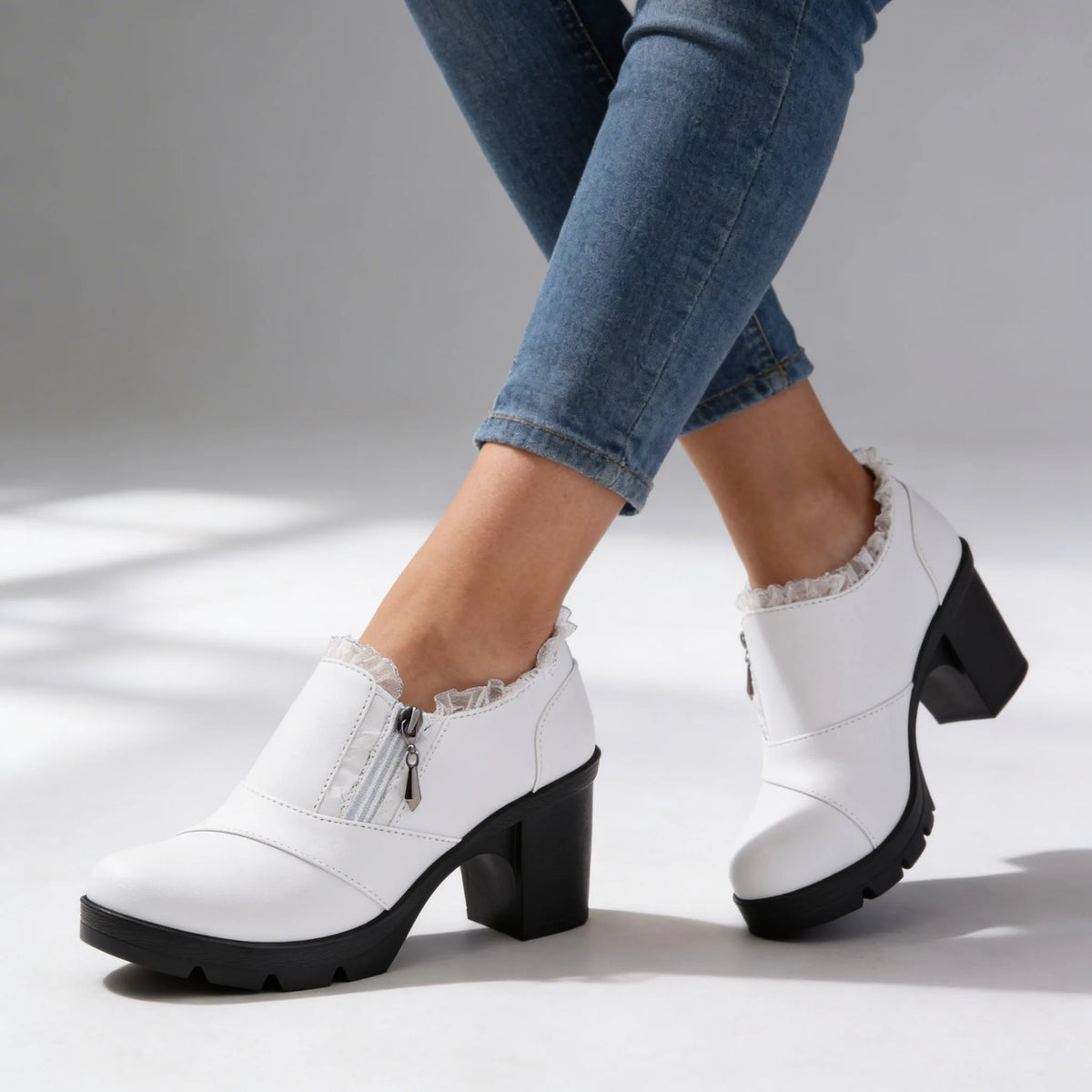 Front angled view of black ankle boots highlighting round toe, platform sole and ridged tread