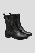 Front three-quarter view of black lace-up combat boots with side zip and buckle strap at the ankle