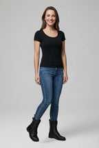 Woman wearing black t-shirt and skinny jeans styled with black lace-up combat boots