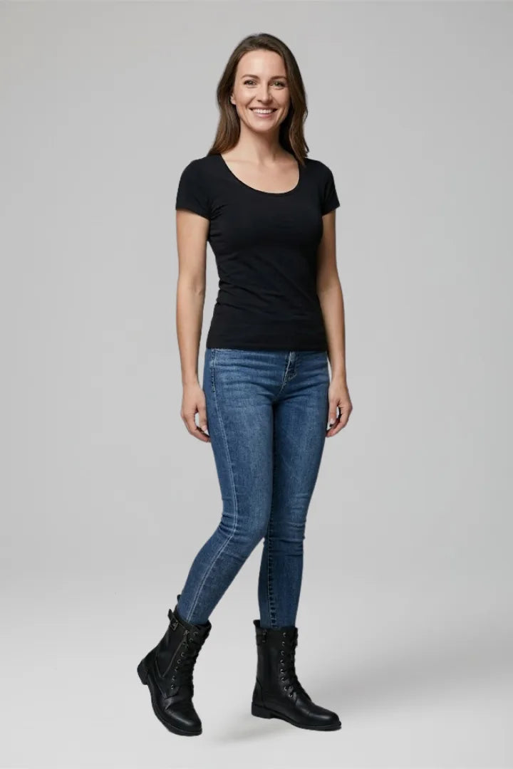 Woman wearing black t-shirt and skinny jeans styled with black lace-up combat boots