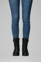 Close-up front view of black lace-up ankle boots with zip fastening and eyelet lacing on jeans