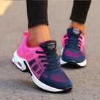 Close-up rear view of pink and navy mesh trainers showing padded heel tab labelled Fashion Professional and lace detail