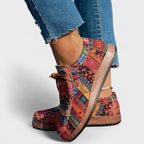 Side back view of red patchwork comfort shoes showing the thick cushioned sole and tan laces.