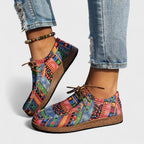 Side profile of pink, blue and green patchwork comfort shoes showing the moccasin-style stitched toe.