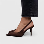 Close-up of dark brown suede slingback heel showing slim stiletto and pointed toe