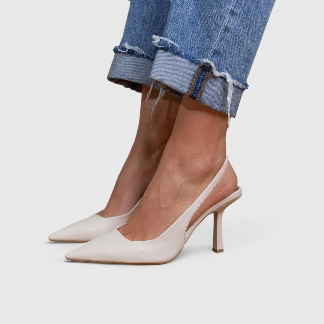 White leather pointed toe slingback heel with slim mid-height heel and cuffed denim