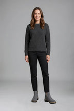 Woman wearing a grey ribbed jumper and black trousers styled with grey ankle boots and gold zip detail