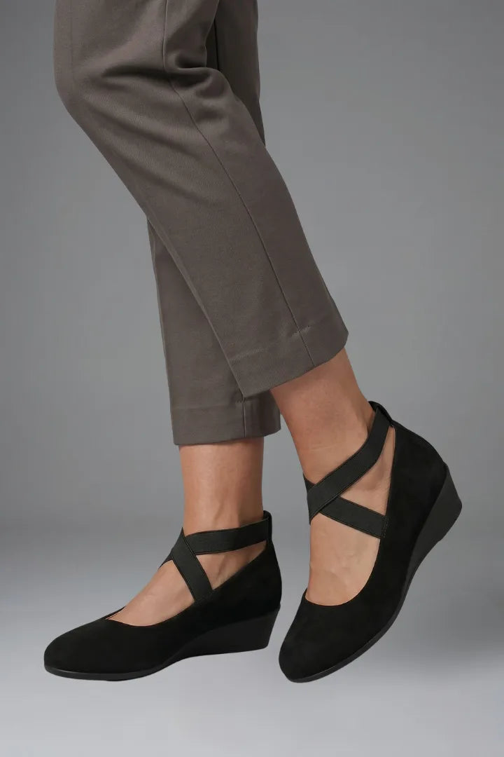 Close-up side profile of black ballet flat showing rounded toe and elastic instep strap