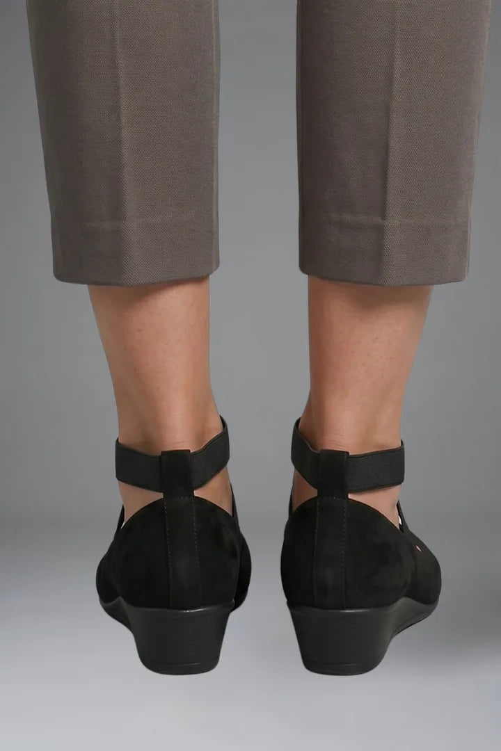 Back view of both black ballet flats showing wedge heel height and heel strap detail