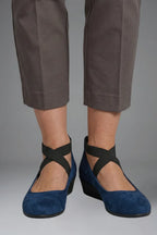 Close-up of red suede ballet flat with crisscross elastic straps across the instep