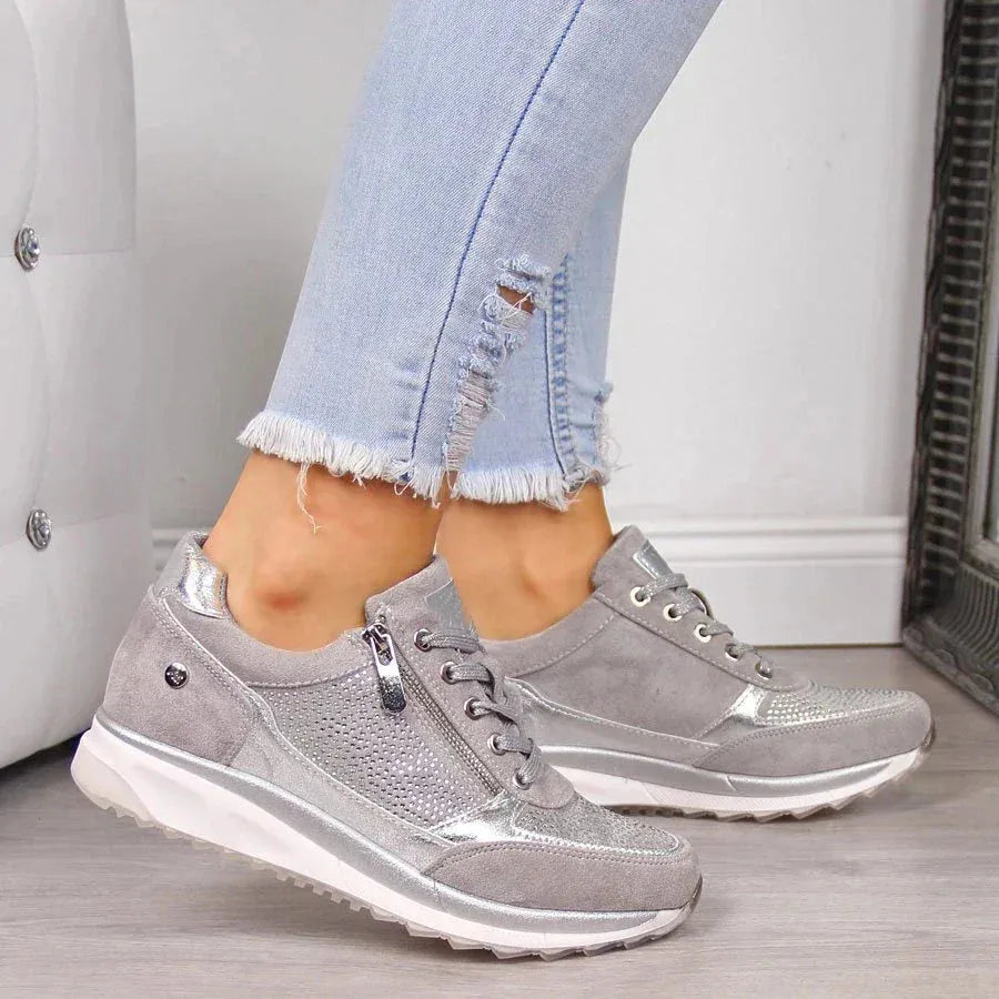 Side view of grey suede lace-up trainer with crystal panel and metallic silver heel accent