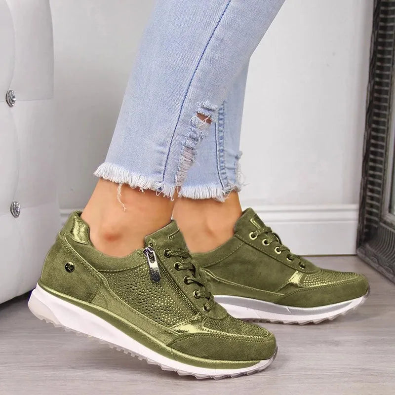 Pair of grey sparkling trainers worn with ripped skinny jeans, shown from the front