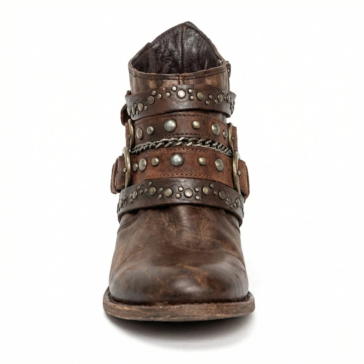 Front view of brown studded ankle boot showing triple buckle straps and chain trim across the vamp