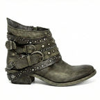 Side view of olive green distressed leather ankle boot with layered studded straps and low block heel