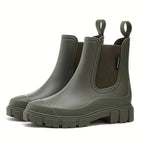 Olive green Chelsea boots with contrasting dark elastic gusset and deep-tread platform sole