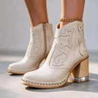 Off-white leather ankle boots with cream stitched panels, studded platform and gold anklet accessory