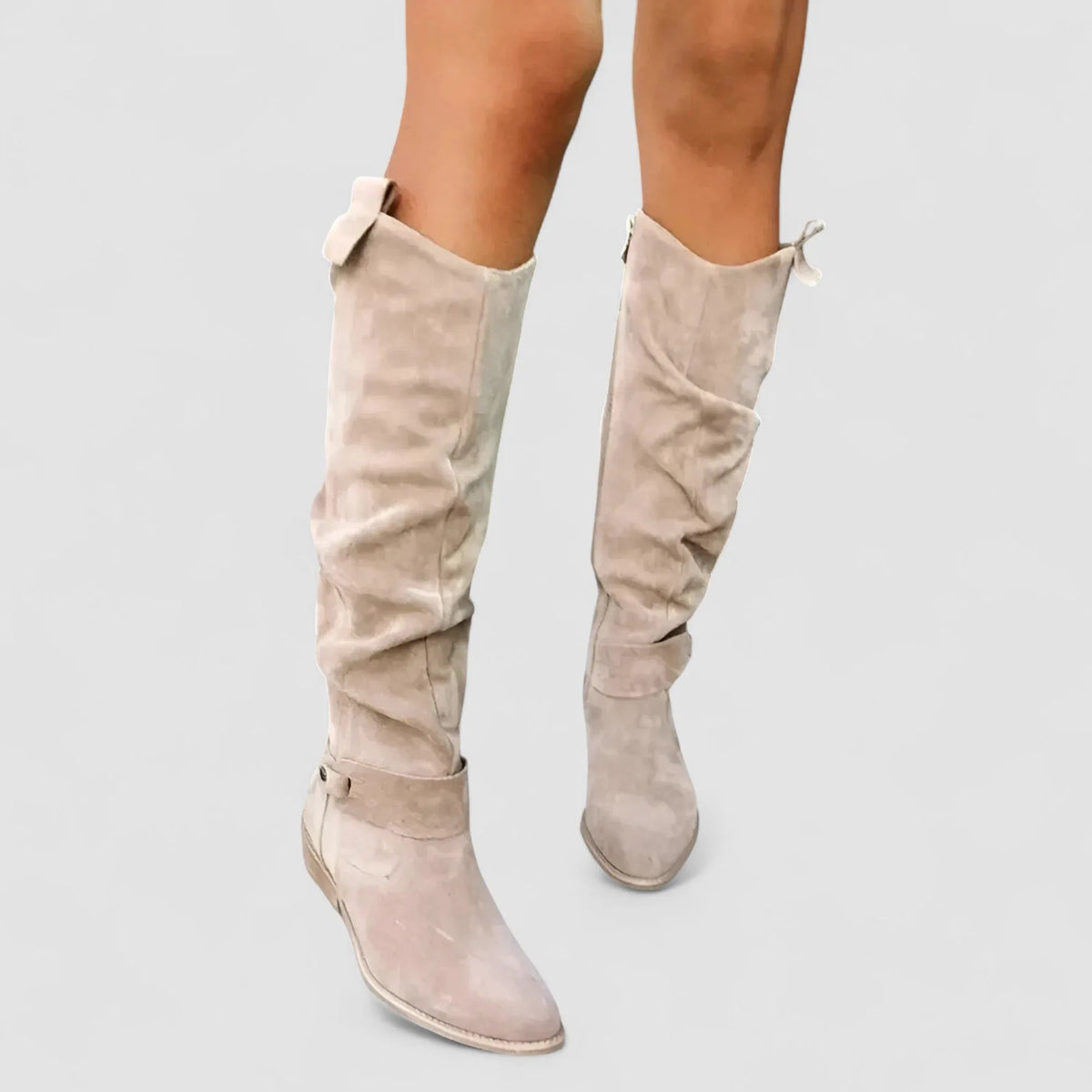 Front view of two beige suede knee-high slouch boots with pull-tab detail at the top