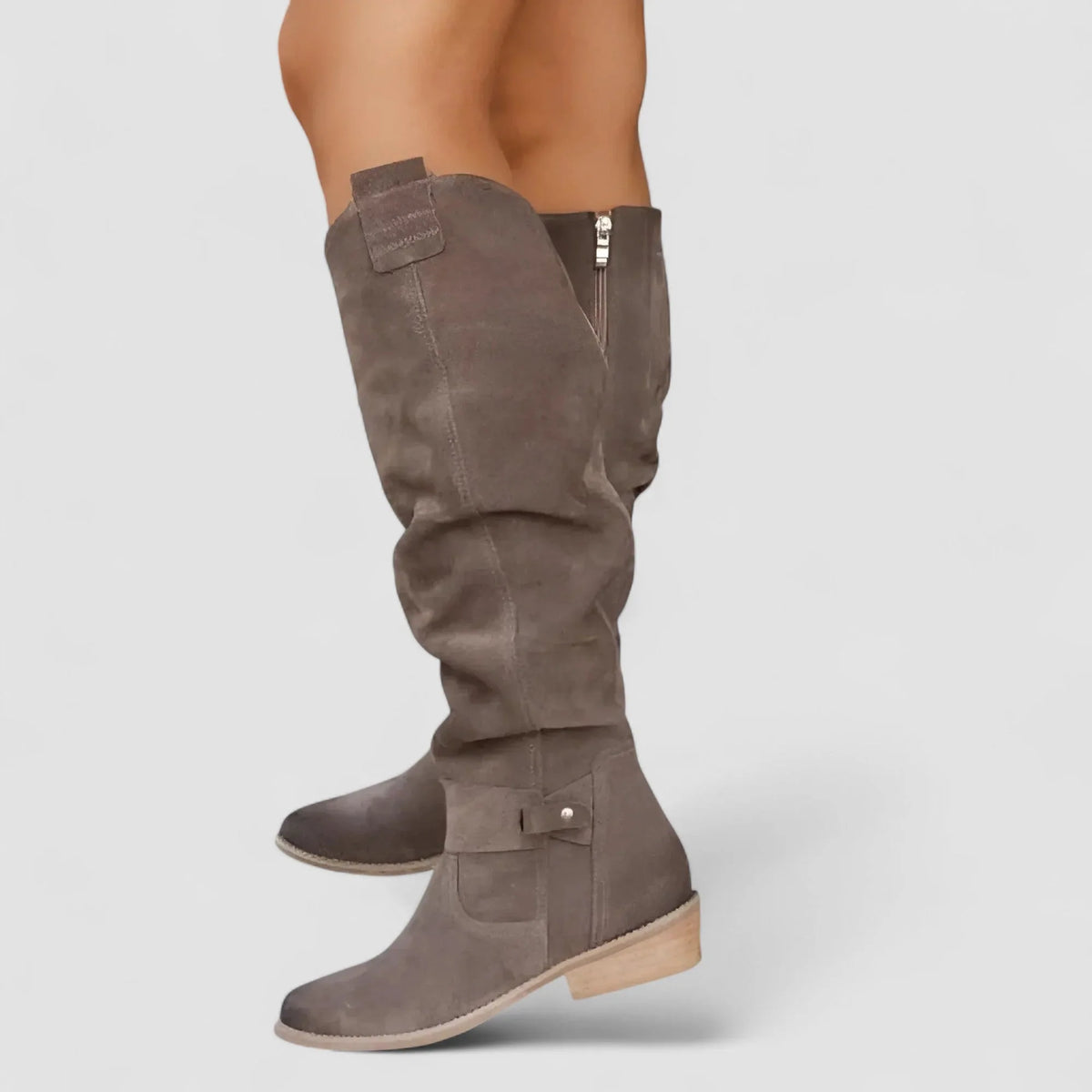 Back and side view of taupe suede knee-high boot showing side zip and ankle strap buckle