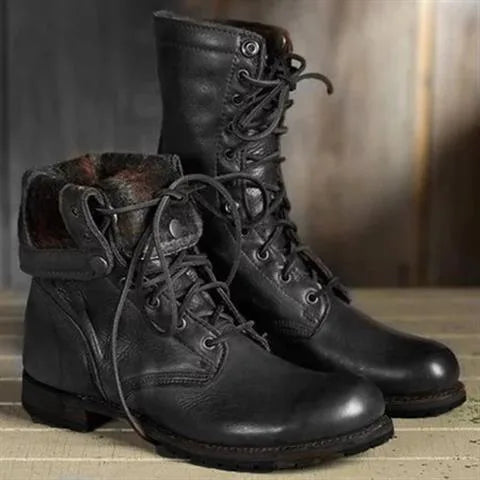 Black leather combat boots with fold-over cuff showing textured lining and lace-up front