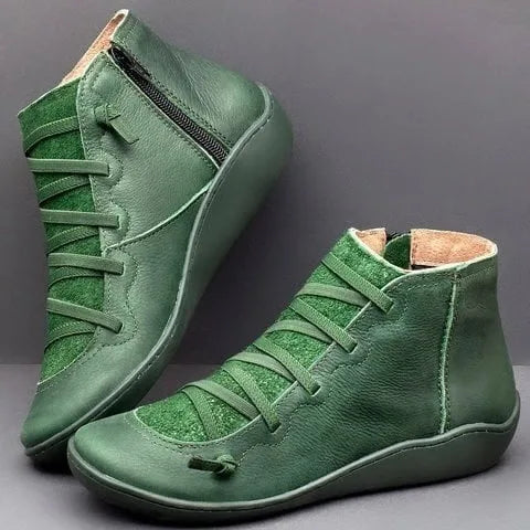 Olive green leather ankle boots with cross lacing and tonal stitching, shown together on grey background
