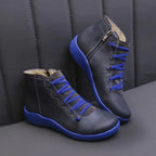 Navy blue leather ankle boots with bold blue laces and matching sole, angled front view