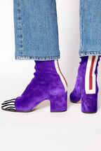 Purple suede ankle boots with zebra-print toe cap, cream and red back trim, and block heel