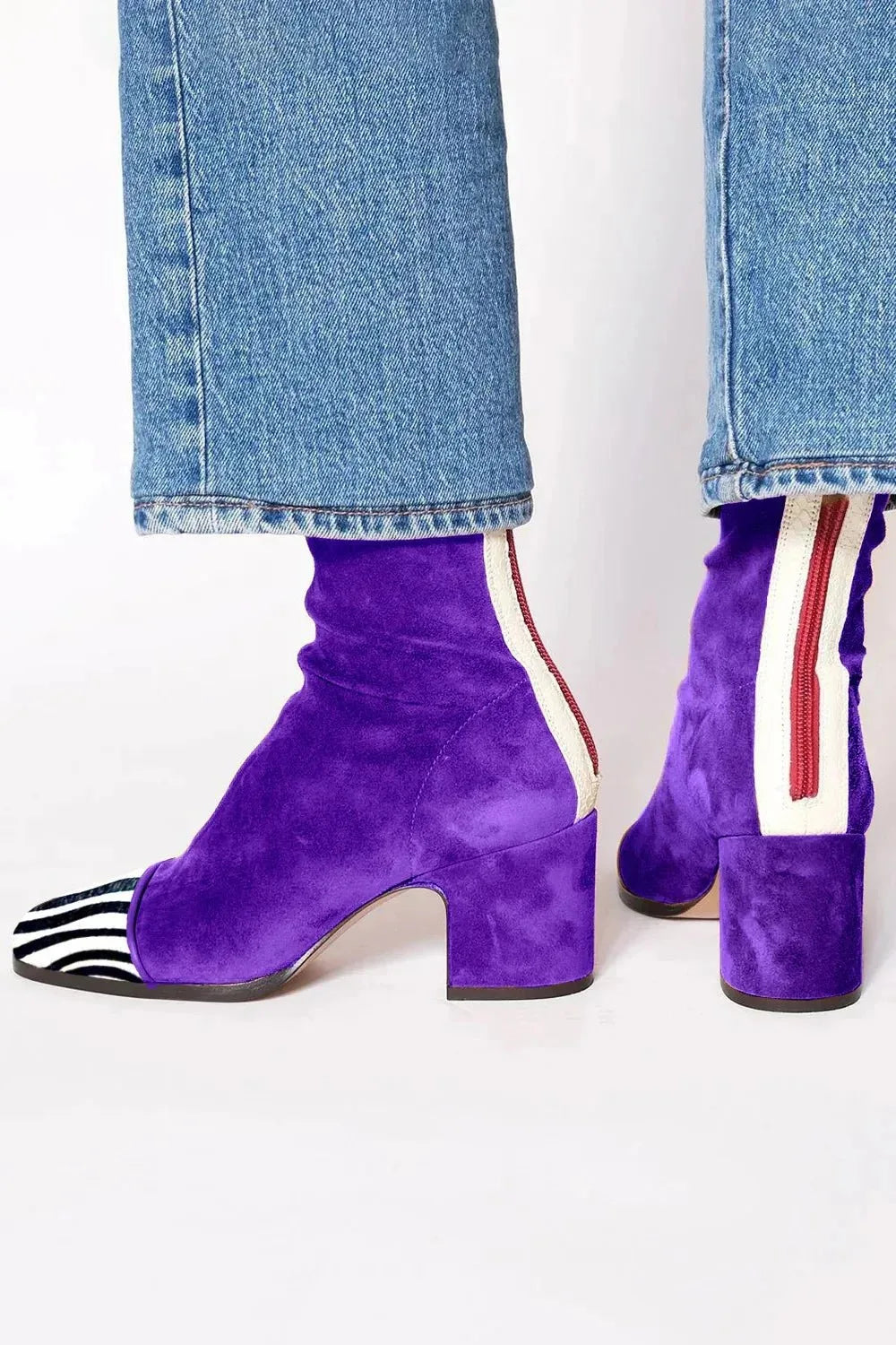 Purple suede ankle boots with zebra-print toe cap, cream and red back trim, and block heel