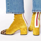 Mustard yellow suede ankle boots with leopard-print toe cap and cream zip trim on the heel