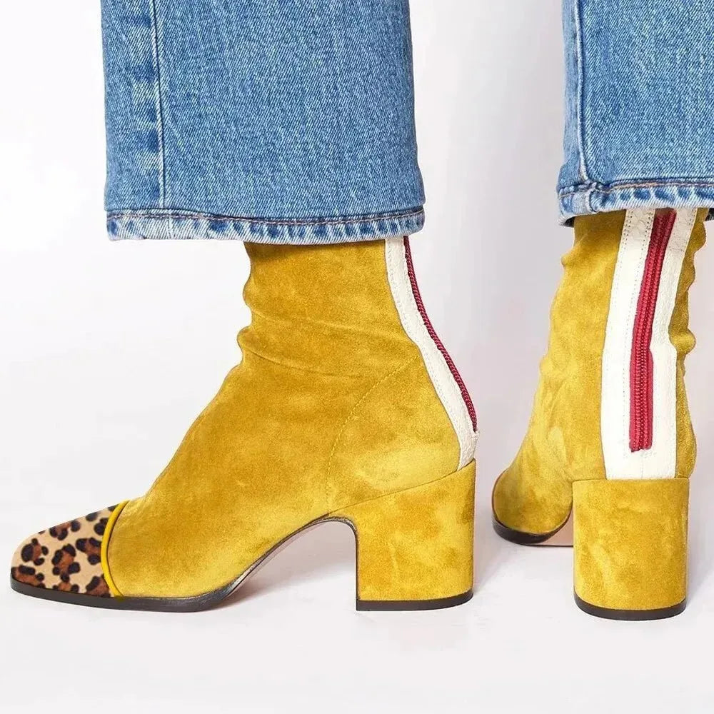 Mustard yellow suede ankle boots with leopard-print toe cap and cream zip trim on the heel