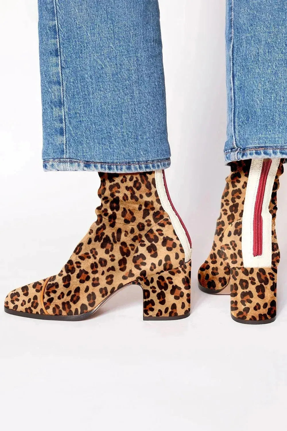 Leopard-print suede ankle boots with cream and red back panel, shown from behind while worn