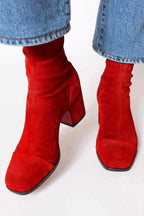Pair of brown suede ankle boots showing the square toe and block heel from a front angle