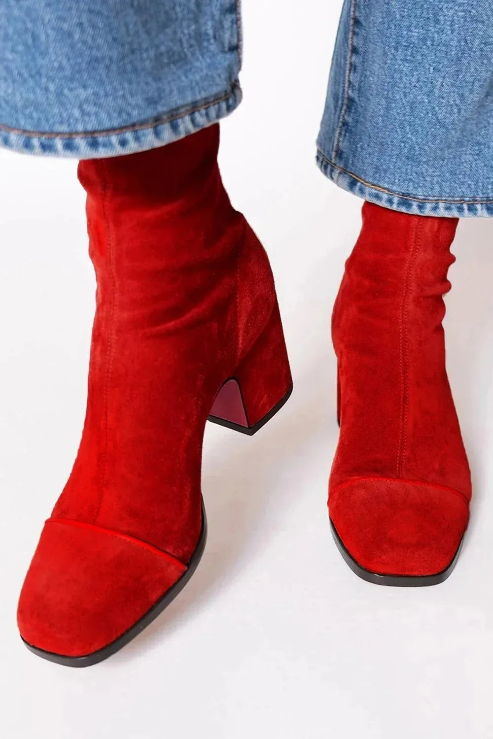 Pair of brown suede ankle boots showing the square toe and block heel from a front angle